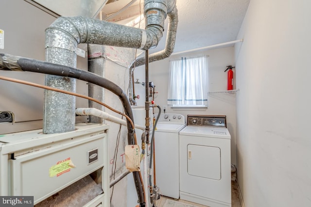 clothes washing area featuring independent washer and dryer