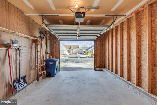 garage with electric panel and a garage door opener