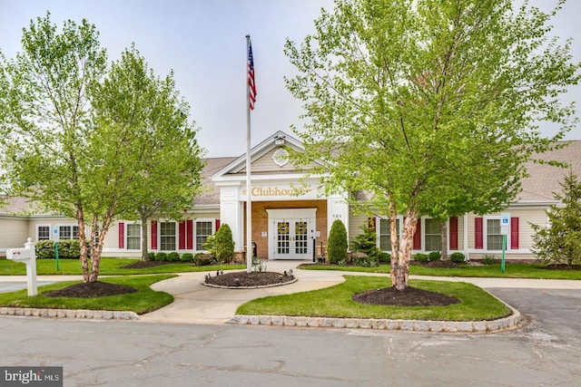 view of front of home featuring french doors and a front lawn