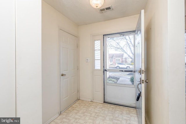 entryway with a textured ceiling