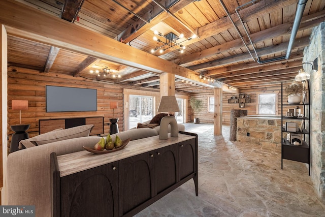 living room with log walls, beam ceiling, a chandelier, and wood ceiling