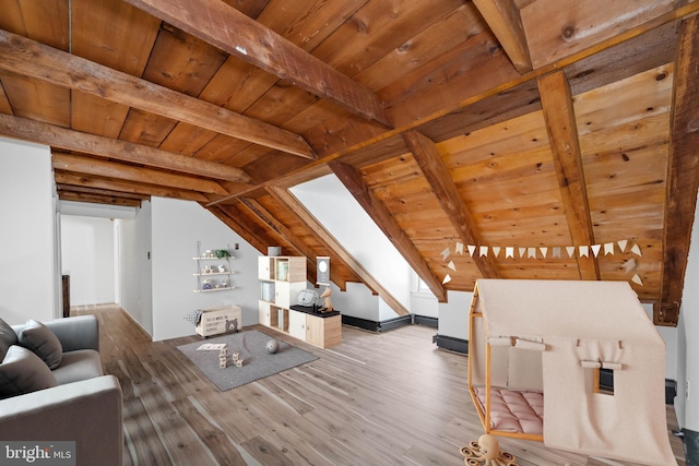 living room featuring hardwood / wood-style flooring, lofted ceiling with beams, and wooden ceiling