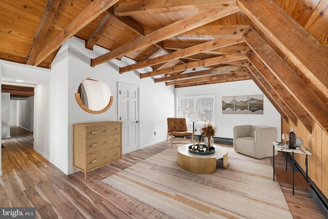 living area with vaulted ceiling with beams, wood ceiling, and light hardwood / wood-style floors