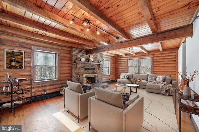 living room with a brick fireplace, light wood-type flooring, log walls, beamed ceiling, and wood ceiling