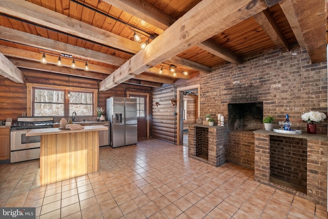 kitchen featuring beam ceiling, rustic walls, wooden ceiling, kitchen peninsula, and appliances with stainless steel finishes