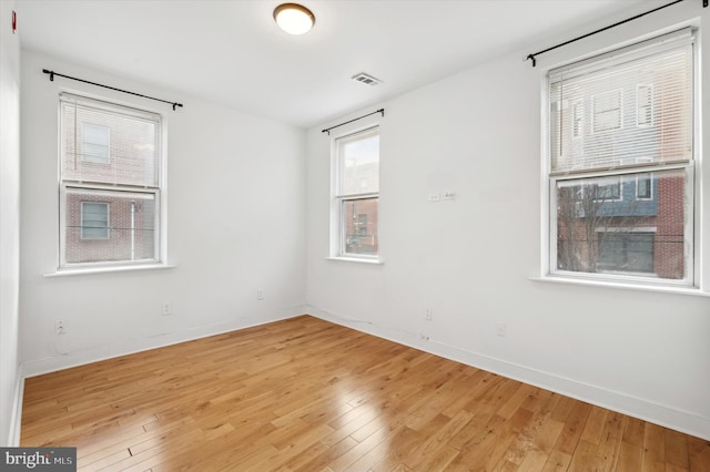 unfurnished room with hardwood / wood-style floors