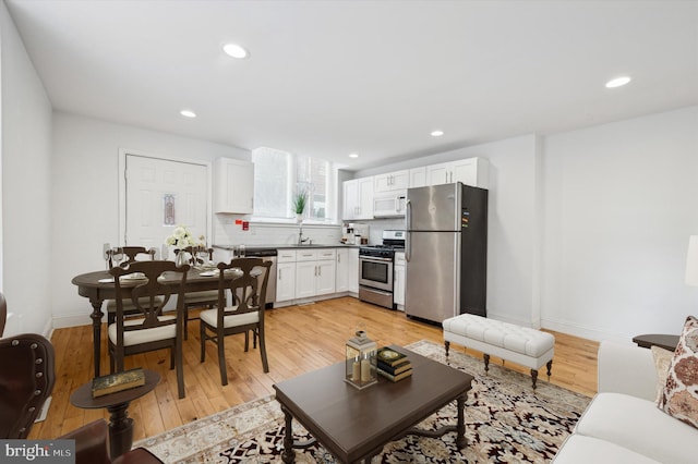 living room featuring light hardwood / wood-style floors and sink