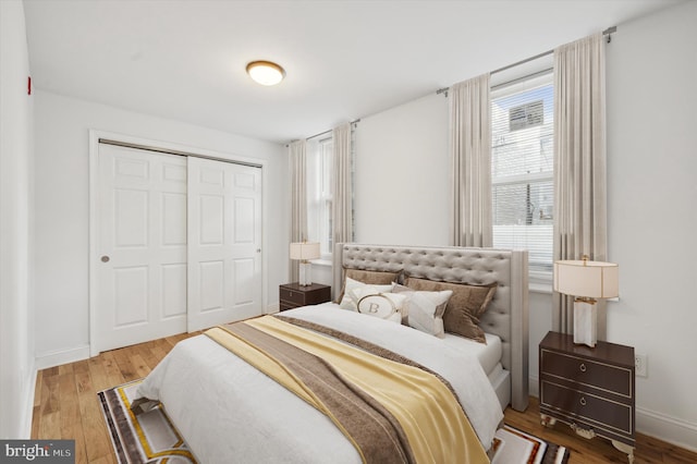 bedroom with hardwood / wood-style flooring and a closet