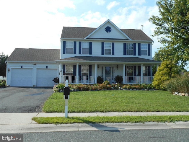 view of front of home with a porch, a garage, and a front yard