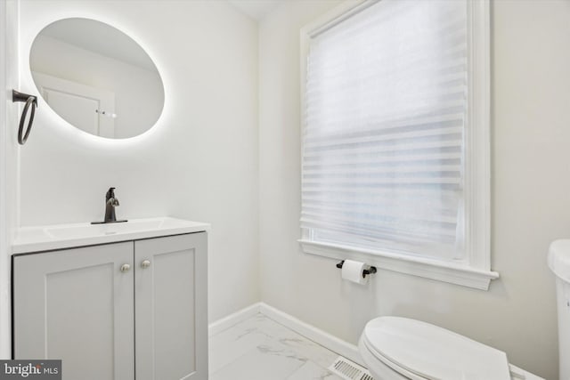 bathroom featuring vanity and toilet