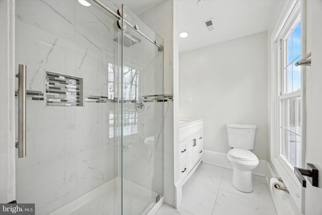 bathroom with an enclosed shower, vanity, a healthy amount of sunlight, and toilet