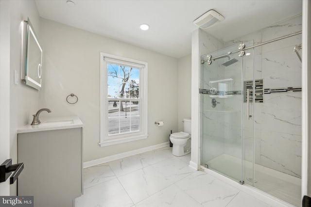 bathroom with vanity, toilet, and a shower with shower door