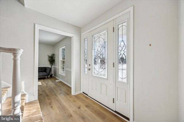 entryway featuring a healthy amount of sunlight and light hardwood / wood-style flooring