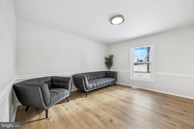 living area with hardwood / wood-style floors