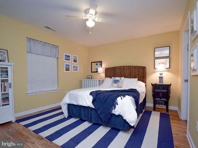 bedroom with ceiling fan and light hardwood / wood-style flooring