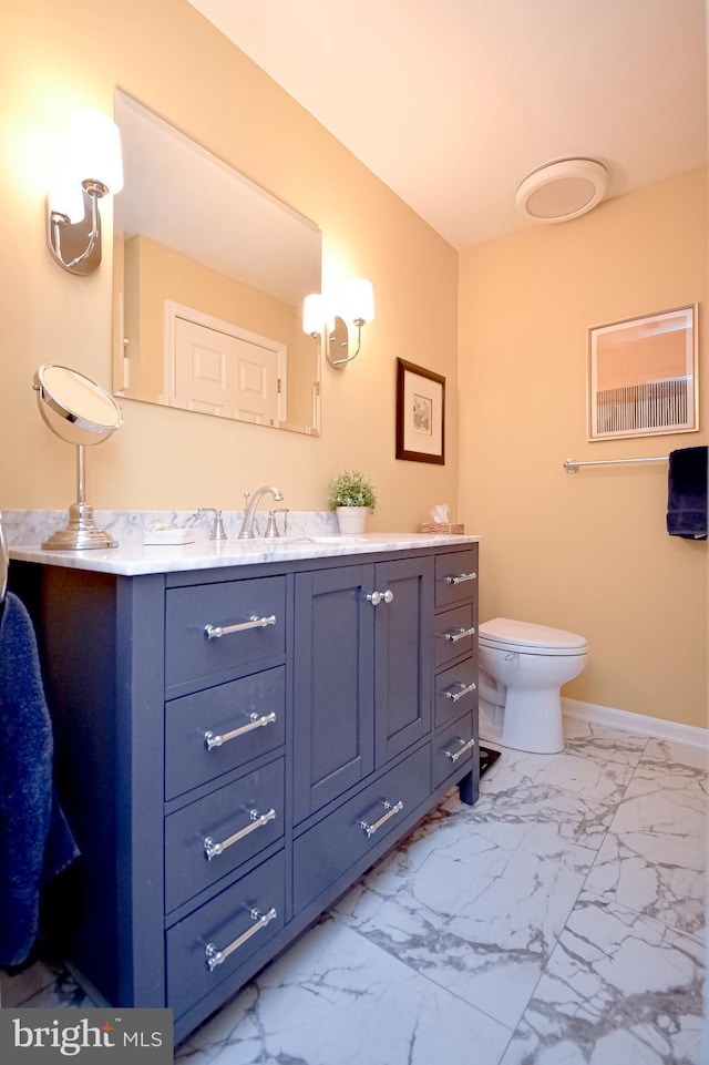 bathroom with vanity and toilet