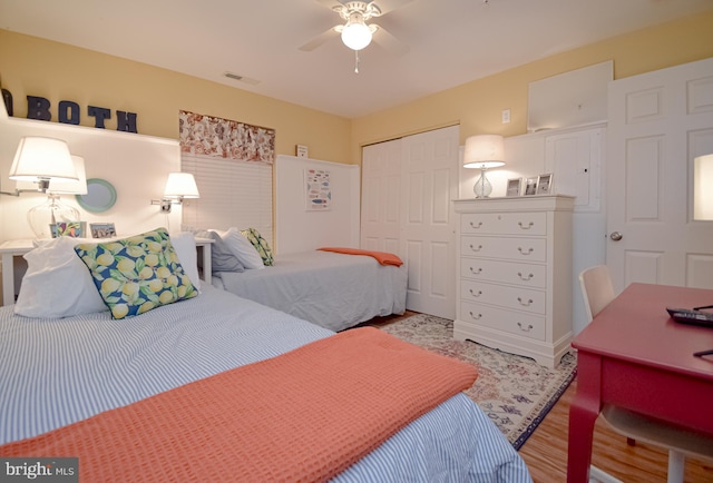 bedroom with hardwood / wood-style floors, a closet, and ceiling fan