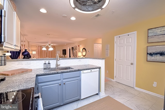 kitchen featuring white cabinetry, sink, light stone counters, kitchen peninsula, and white dishwasher