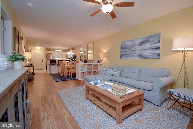 living room featuring ceiling fan and light hardwood / wood-style flooring