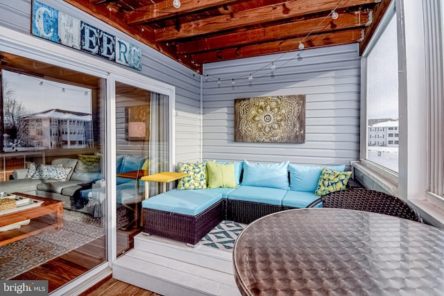 sunroom with beam ceiling and a wealth of natural light