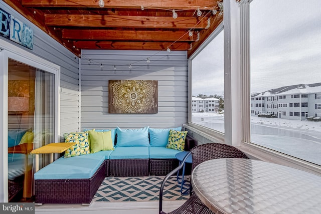 sunroom with beamed ceiling