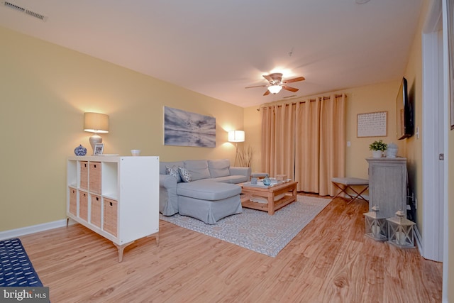 living room featuring ceiling fan and wood-type flooring