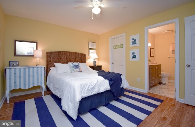 bedroom with light wood-type flooring, connected bathroom, and ceiling fan