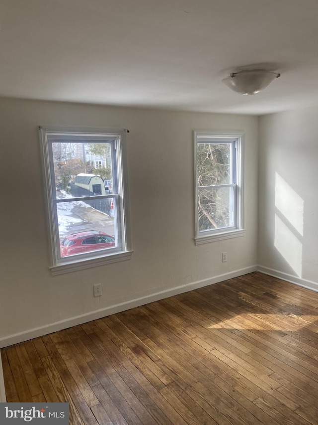 spare room featuring dark wood-type flooring