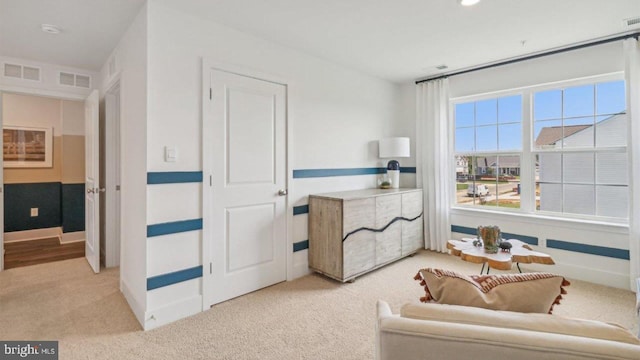 sitting room featuring light colored carpet