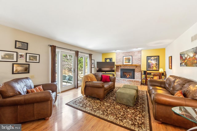 living room featuring wood-type flooring and a fireplace