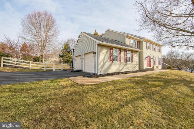 view of front of home featuring a garage and a front lawn