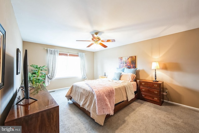 bedroom with light carpet and ceiling fan