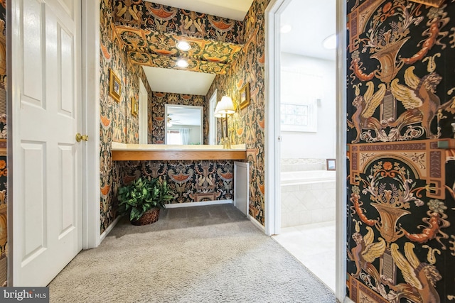 bathroom featuring vanity and a relaxing tiled tub