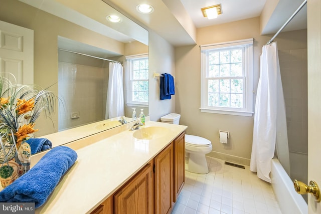 full bathroom with vanity, tile patterned floors, toilet, and shower / bath combo