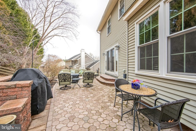 view of patio featuring a grill