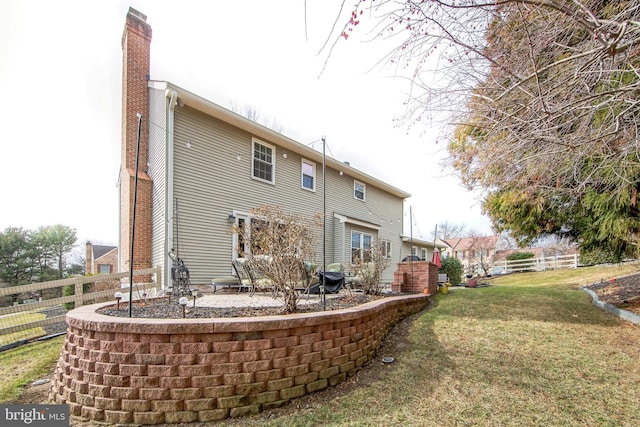 rear view of house featuring a lawn