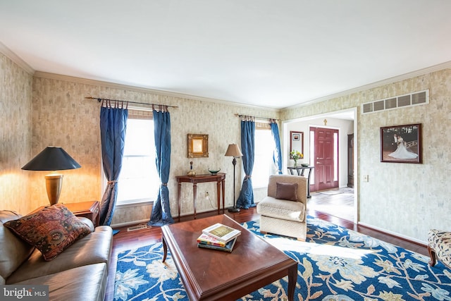 living room with hardwood / wood-style floors, plenty of natural light, and ornamental molding