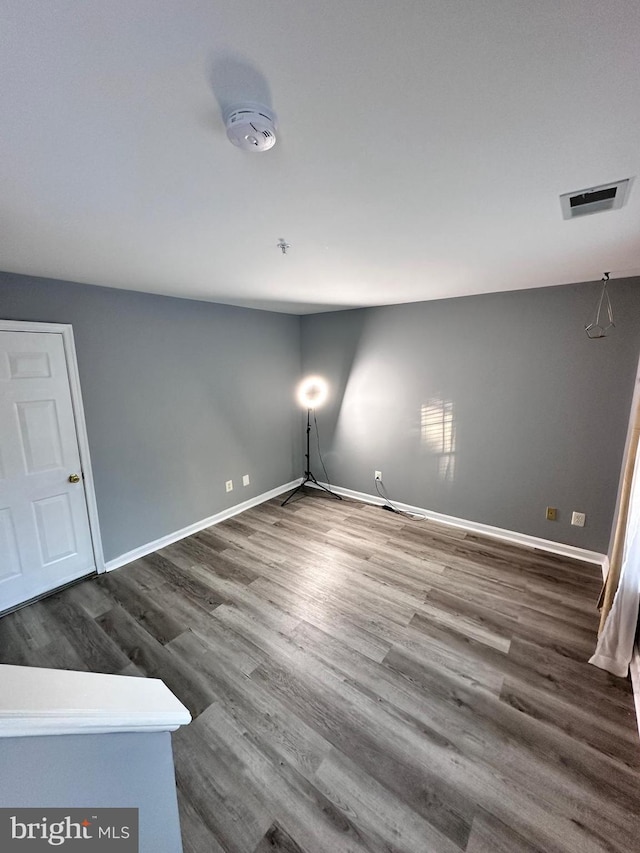 empty room with dark hardwood / wood-style floors