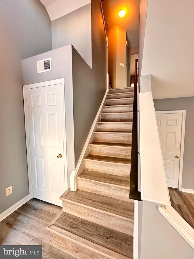 stairway with hardwood / wood-style flooring