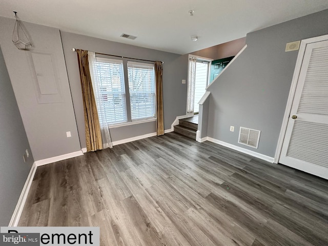 unfurnished living room featuring dark wood-type flooring