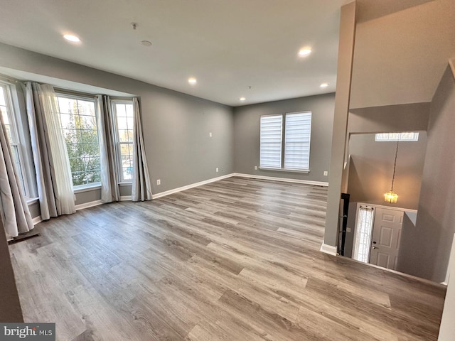 unfurnished living room featuring hardwood / wood-style flooring