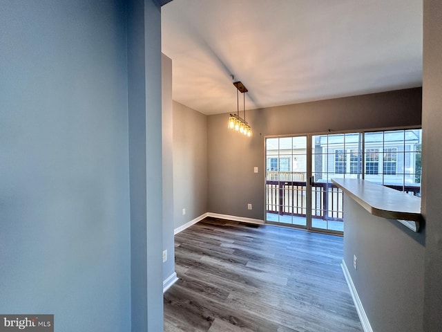 interior space with wood-type flooring and an inviting chandelier