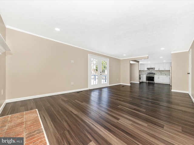 unfurnished living room with dark hardwood / wood-style floors, crown molding, and french doors