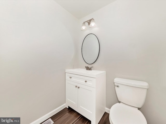 bathroom featuring hardwood / wood-style floors, vanity, and toilet