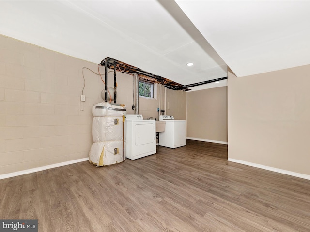 basement featuring hardwood / wood-style floors and separate washer and dryer