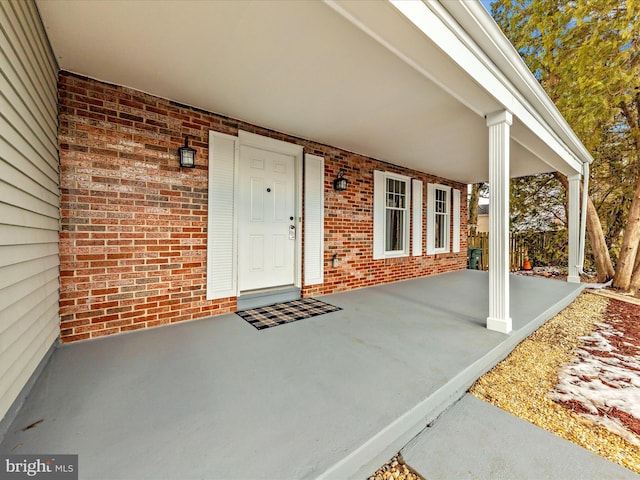 view of exterior entry with a porch