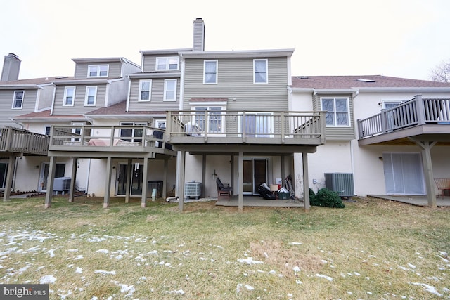 rear view of house with a patio area and cooling unit