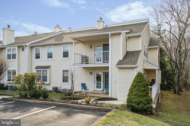 view of front of property with central AC and a balcony