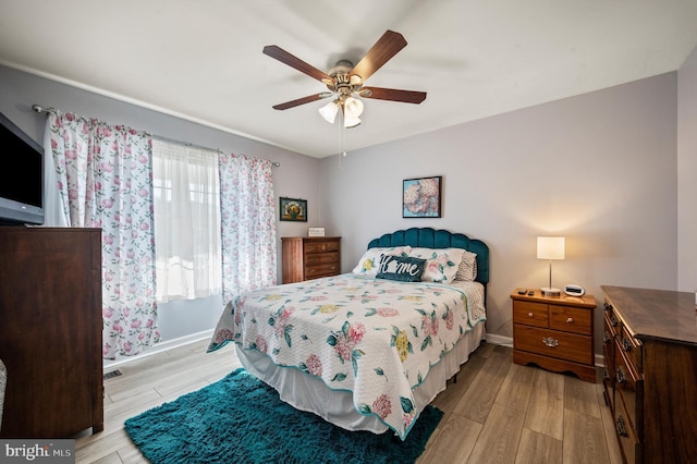 bedroom with ceiling fan and light wood-type flooring