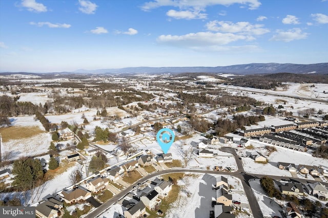 snowy aerial view with a mountain view